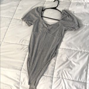 Grey shirt sleeved body suit